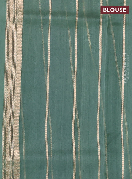 Banarasi organza saree pastel green with zari woven buttas in borderless style