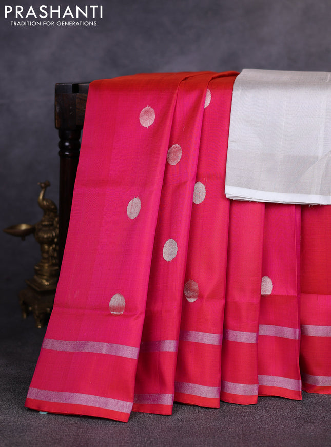 Pure uppada silk saree dual shade of pinkish orange with allover silver zari woven coin buttas and rettapet zari woven border