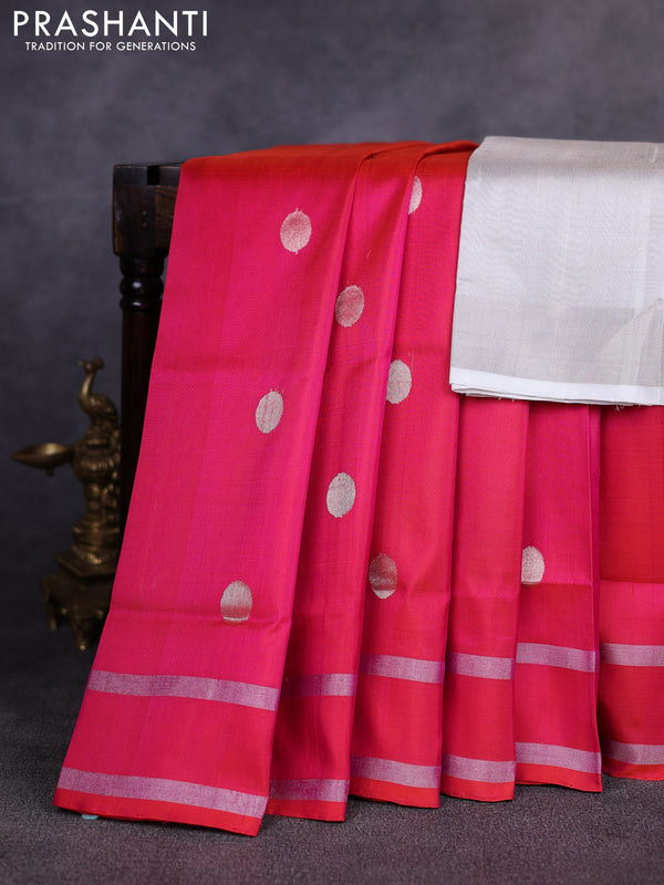 Pure uppada silk saree dual shade of pinkish orange with allover silver zari woven coin buttas and rettapet zari woven border