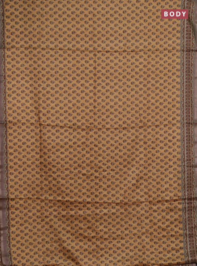 Semi tussar saree sandal and brown with allover floral buttas and printed zari woven border
