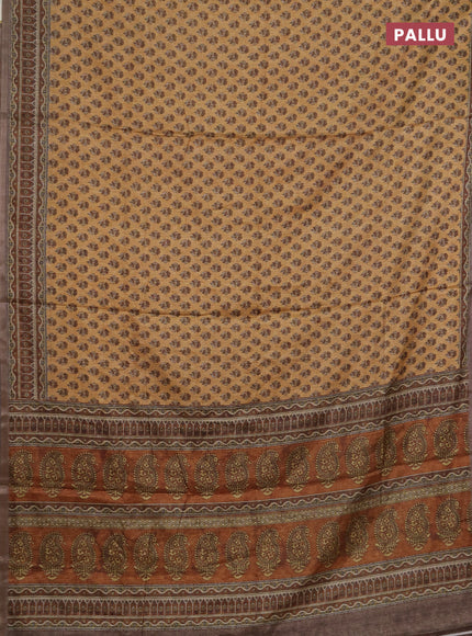 Semi tussar saree sandal and brown with allover floral buttas and printed zari woven border