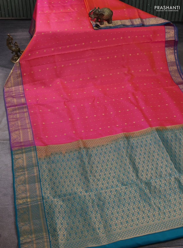 Pure soft silk saree dual shade of pinkish orange and teal green with allover zari woven buttas and zari woven border