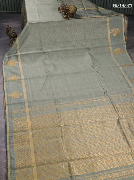 Pure dupion silk saree chiku with allover zari stripe pattern and rettapet zari woven butta border