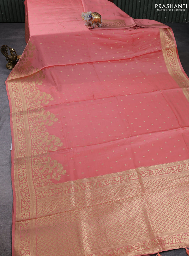 Banarasi silk saree peach shade with allover floral zari woven buttas and long zari woven border