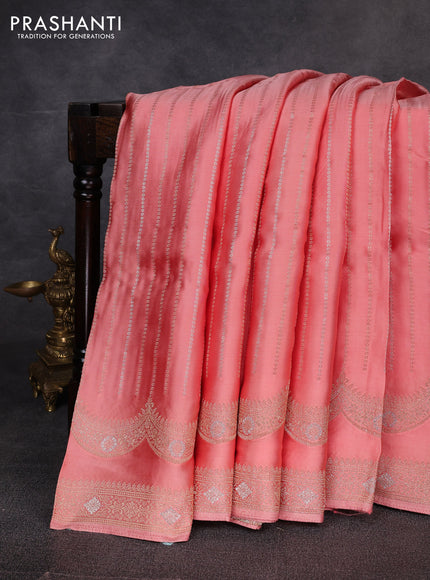 Banarasi silk saree peach shade with allover zari stripe pattern and zari woven border