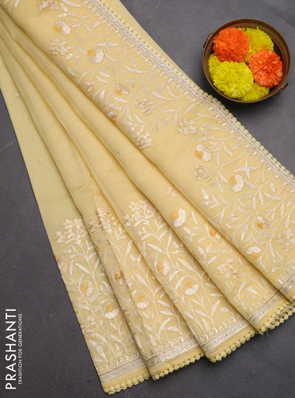Semi Chanderi Saree pale yellow with allover mirror embroidery buttas and corsha lace work border