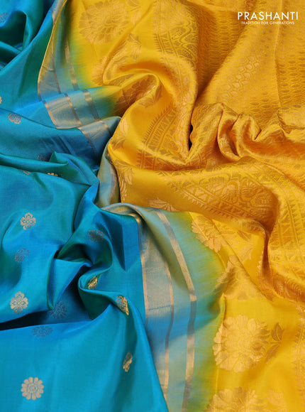 Pure gadwal silk saree dual shade of bluish green and yellow with allover zari woven buttas and temple design convent embroidery