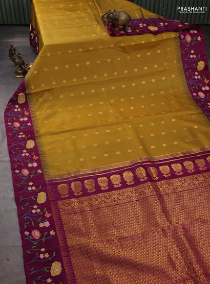 Pure gadwal silk saree dark mustard and purple with allover zari woven buttas and temple design convent embroidery