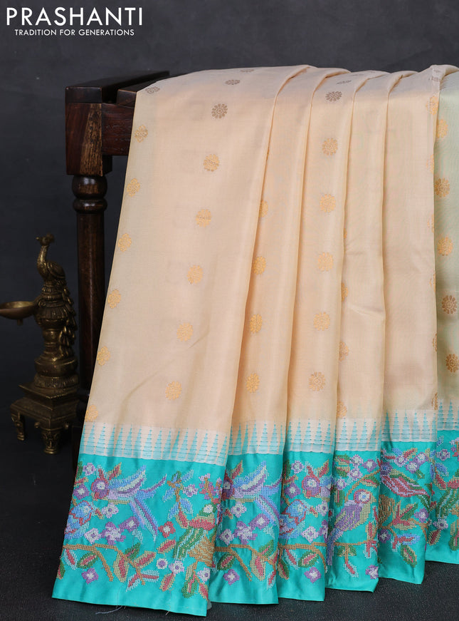Pure gadwal silk saree cream and teal green with allover zari woven buttas and temple design convent embroidery