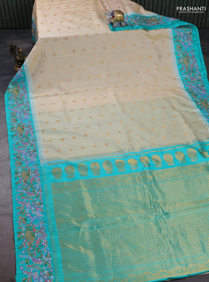Pure gadwal silk saree cream and teal green with allover zari woven buttas and temple design convent embroidery