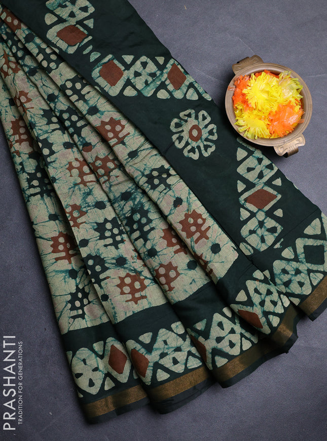 Muslin cotton saree bottle green with allover batik prints and zari woven border