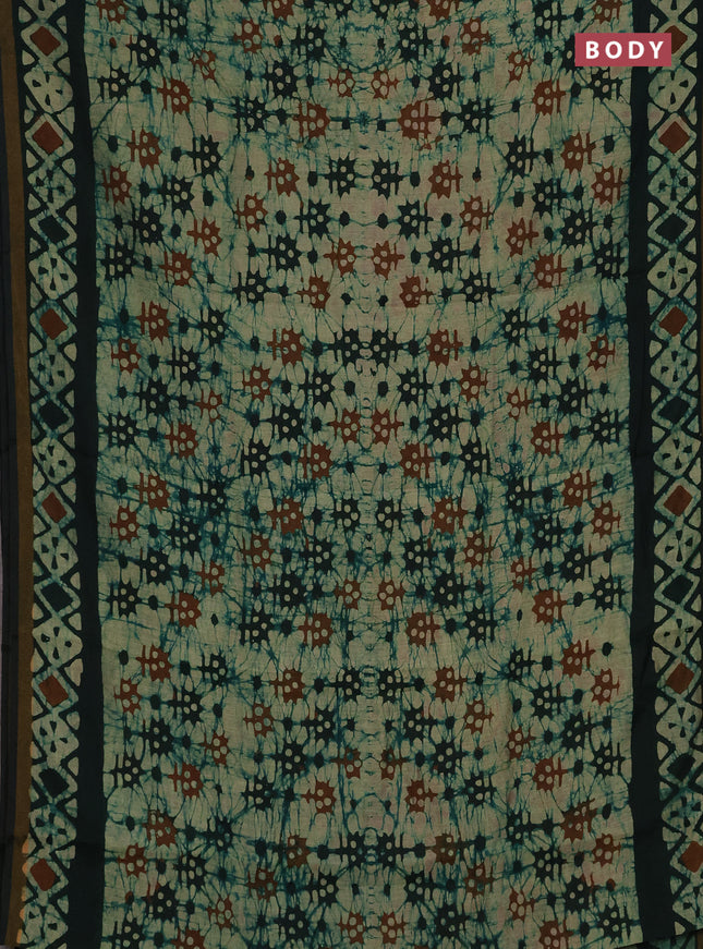 Muslin cotton saree bottle green with allover batik prints and zari woven border
