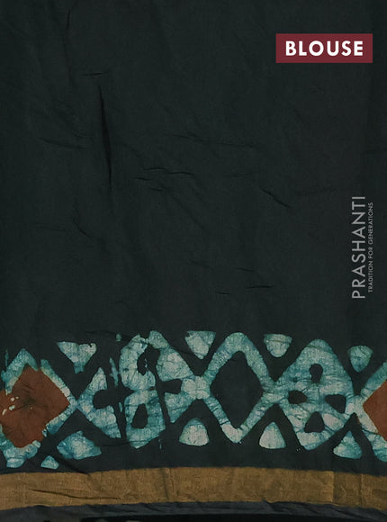Muslin cotton saree bottle green with allover batik prints and zari woven border