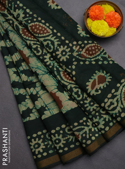 Muslin cotton saree bottle green with allover batik prints and zari woven border