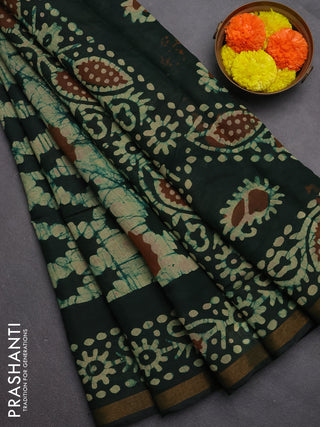 Muslin cotton saree bottle green with allover batik prints and zari woven border
