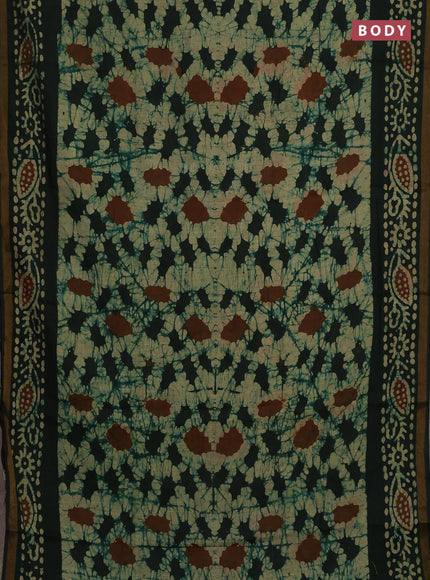 Muslin cotton saree bottle green with allover batik prints and zari woven border