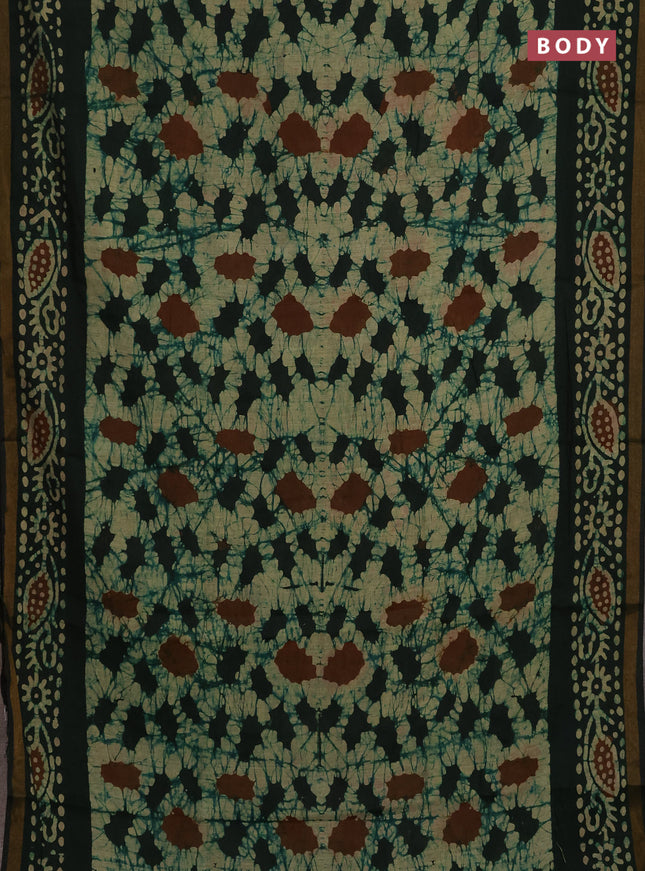 Muslin cotton saree bottle green with allover batik prints and zari woven border