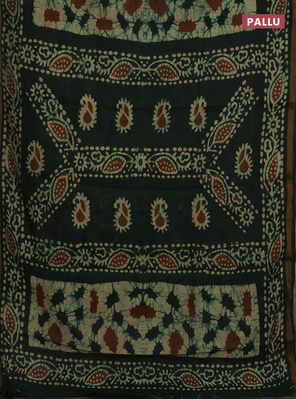 Muslin cotton saree bottle green with allover batik prints and zari woven border
