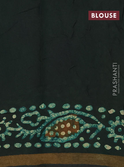 Muslin cotton saree bottle green with allover batik prints and zari woven border