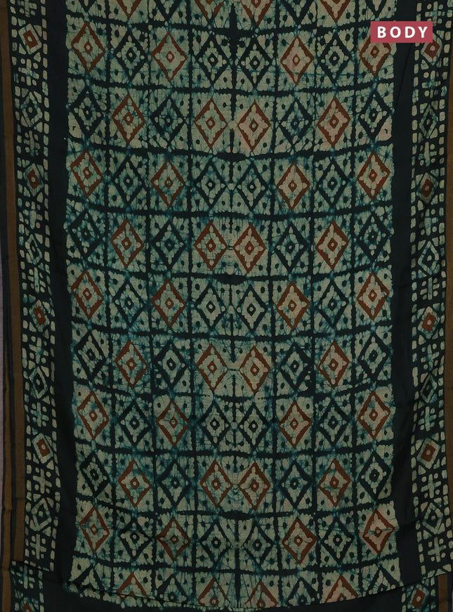 Muslin cotton saree bottle green with allover batik prints and zari woven border