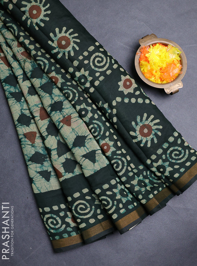 Muslin cotton saree bottle green with allover batik prints and zari woven border