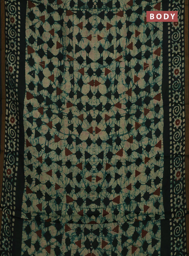 Muslin cotton saree bottle green with allover batik prints and zari woven border