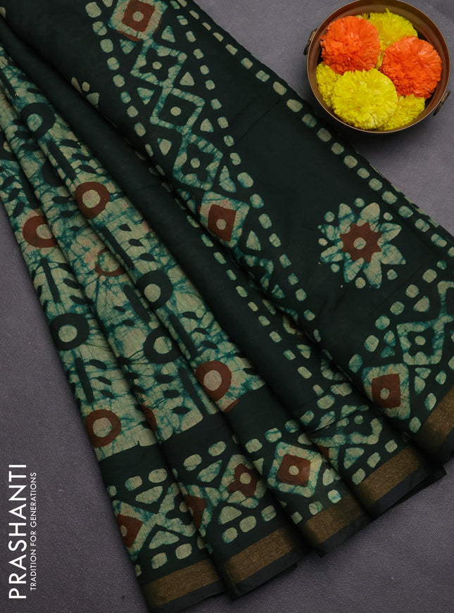 Muslin cotton saree bottle green with allover batik prints and zari woven border
