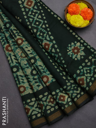 Muslin cotton saree bottle green with allover batik prints and zari woven border