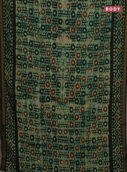 Muslin cotton saree bottle green with allover batik prints and zari woven border