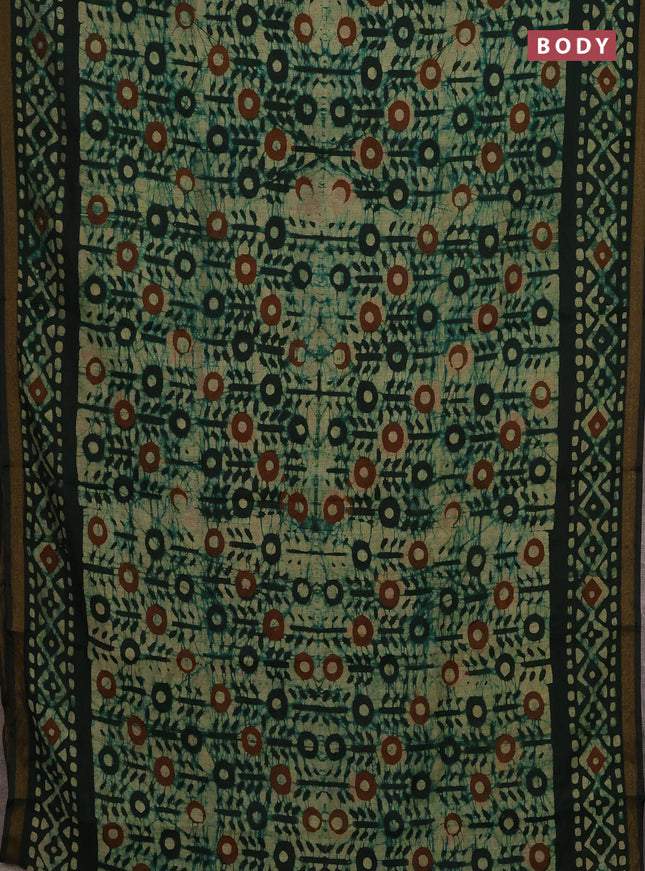 Muslin cotton saree bottle green with allover batik prints and zari woven border