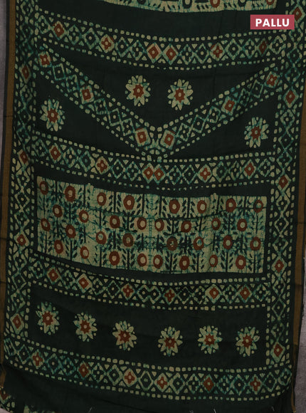 Muslin cotton saree bottle green with allover batik prints and zari woven border