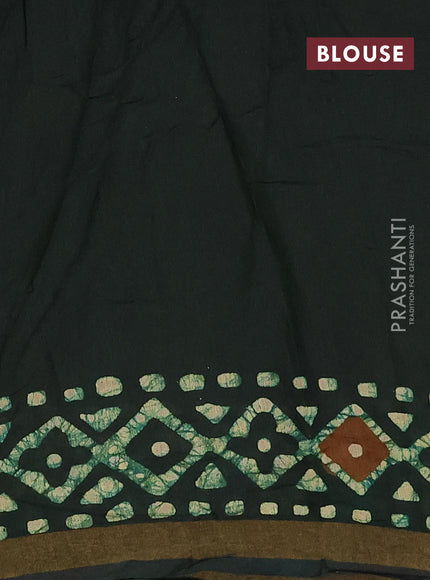 Muslin cotton saree bottle green with allover batik prints and zari woven border