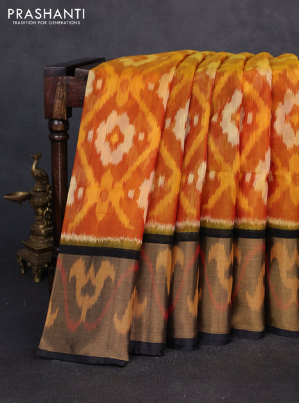 Ikat silk cotton saree orange and black with allover ikat weaves and long zari woven border