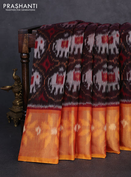 Ikat silk cotton saree black and orange with allover ikat weaves and long zari woven border