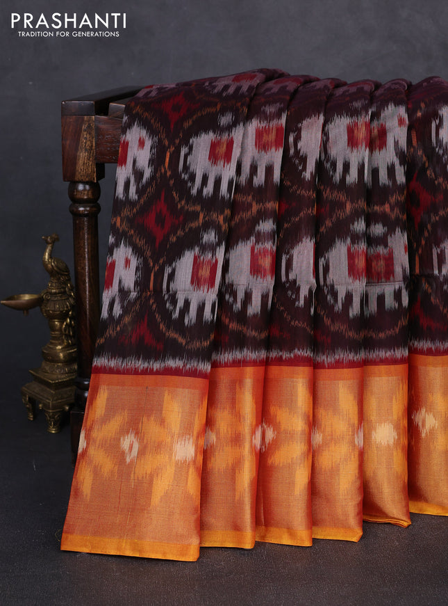 Ikat silk cotton saree black and orange with allover ikat weaves and long zari woven border