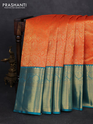 Pure kanchipuram silk saree orange and teal green with allover zari woven brocade weaves and long rich zari woven korvai border