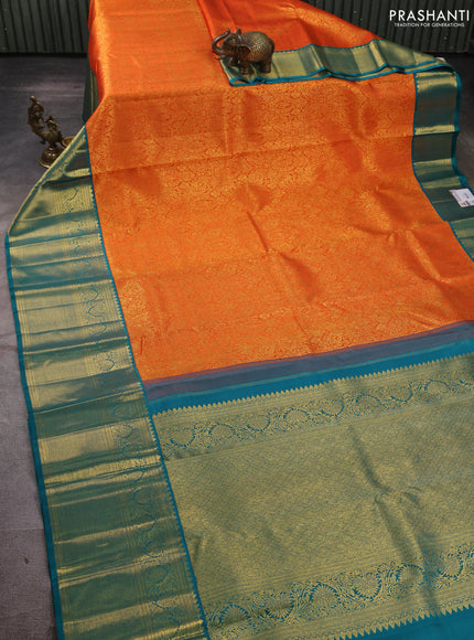 Pure kanchipuram silk saree orange and teal green with allover zari woven brocade weaves and long rich zari woven korvai border