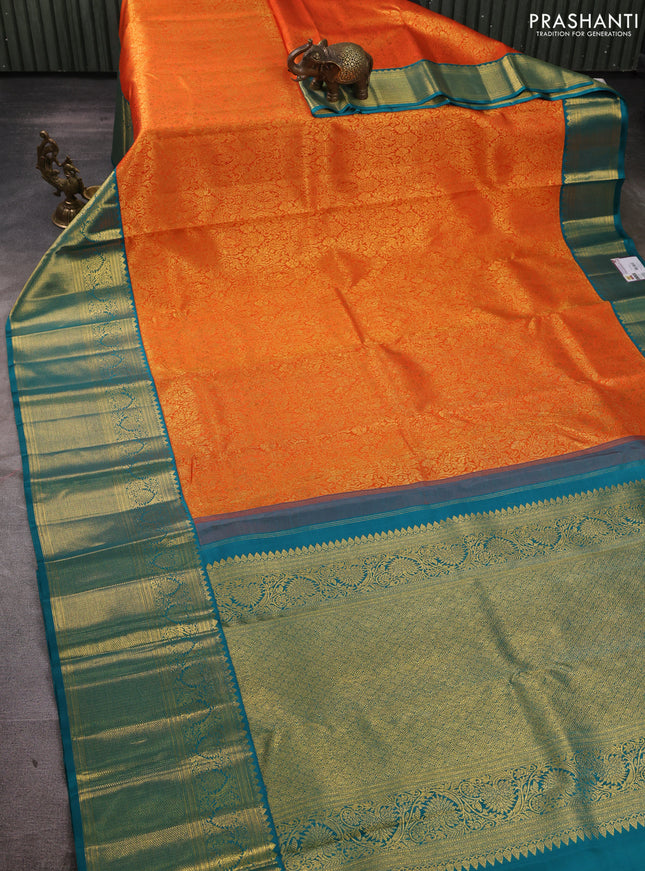 Pure kanchipuram silk saree orange and teal green with allover zari woven brocade weaves and long rich zari woven korvai border