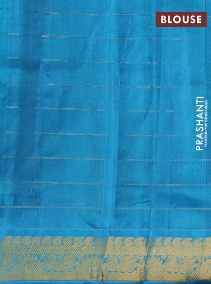 Silk cotton saree bottle green and cs blue with allover zari checks & buttas and zari woven border