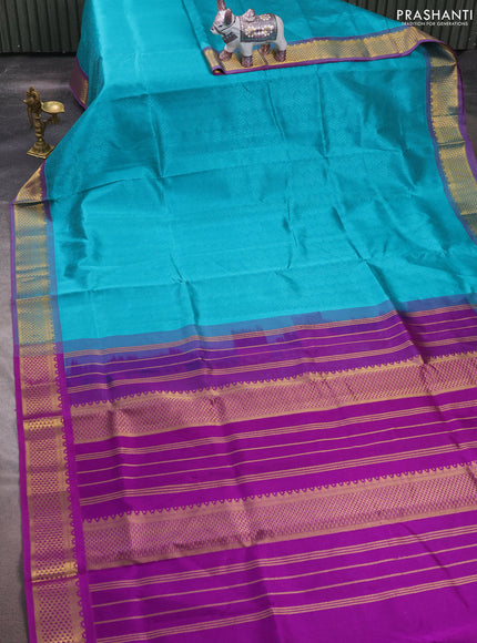 Silk cotton saree teal blue and purple with allover self emboss jacquard and zari woven border