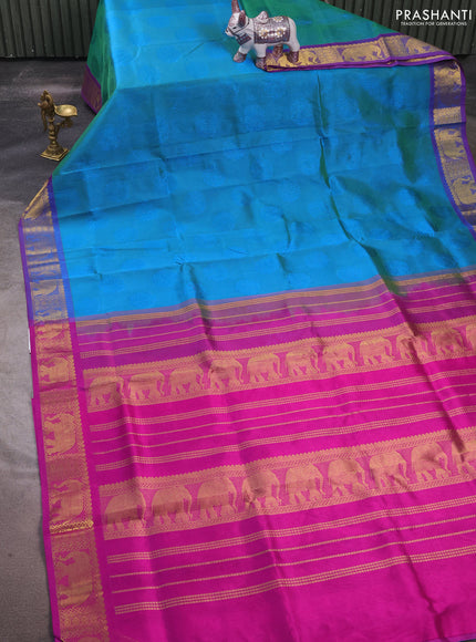 Silk cotton saree dual shade of teal bluish green and purple with allover self emboss jacquard and elephant zari woven border
