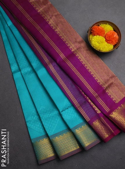 Silk cotton saree teal blue and purple with allover self emboss jacquard and zari woven border