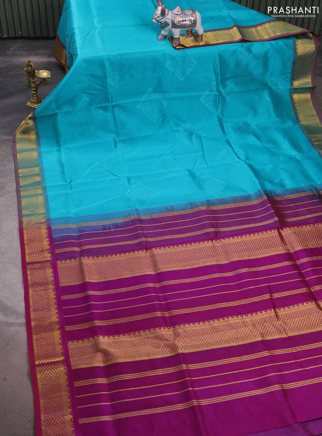 Silk cotton saree teal blue and purple with allover self emboss jacquard and zari woven border