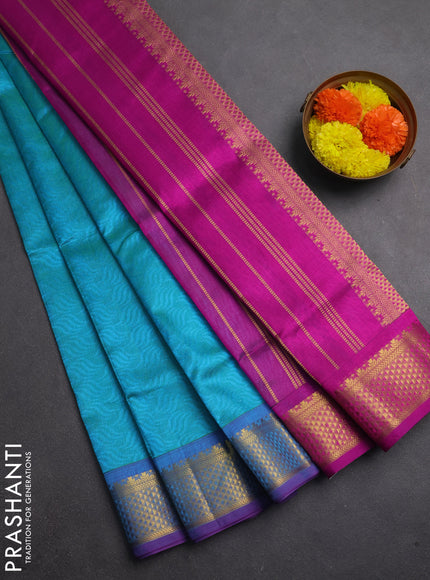 Silk cotton saree dual shade of teal bluish green and purple with allover self emboss jacquard and zari woven border