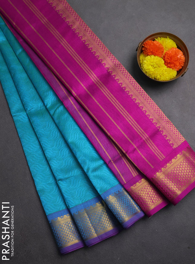 Silk cotton saree dual shade of teal bluish green and purple with allover self emboss jacquard and zari woven border