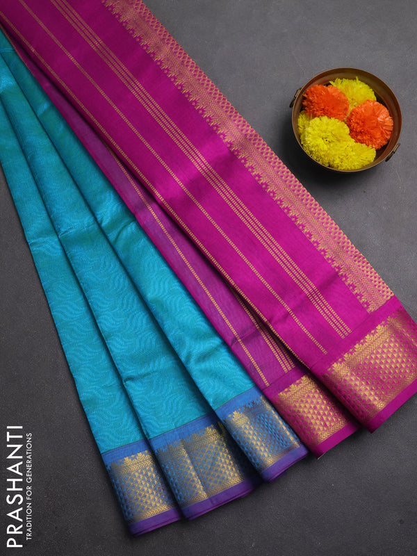 Silk cotton saree dual shade of teal bluish green and purple with allover self emboss jacquard and zari woven border