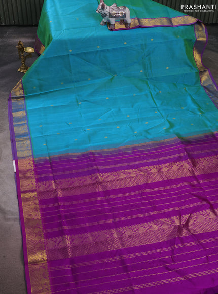 Silk cotton saree dual shade of teal bluish green and purple with zari woven buttas and zari woven border