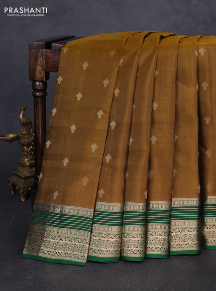 Kanchipuram silk saree dark mustard and green with allover zari woven buttas and zari woven border