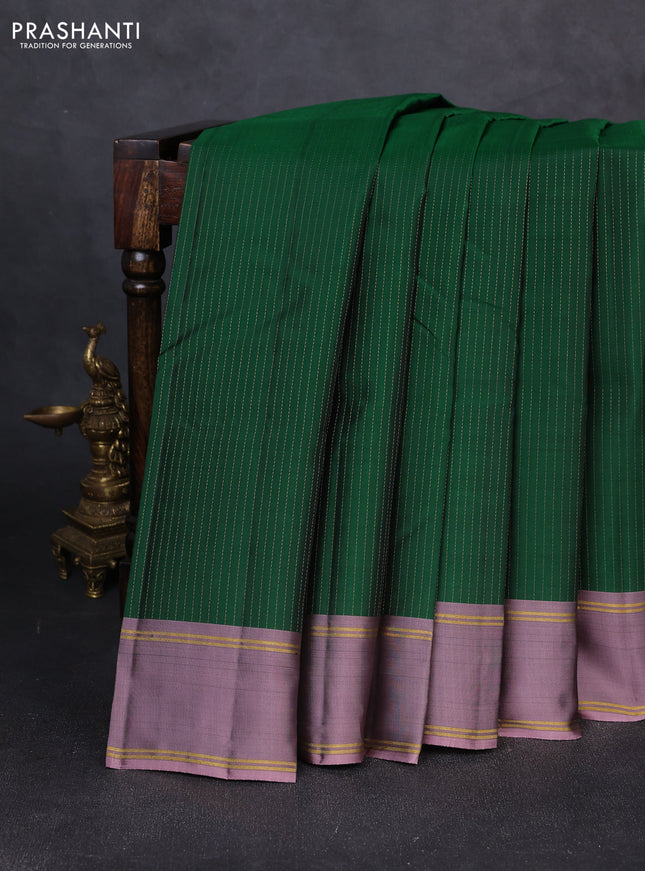 Kanchipuram silk saree green and pastel purple with allover zari weaves and rettapet zari woven border
