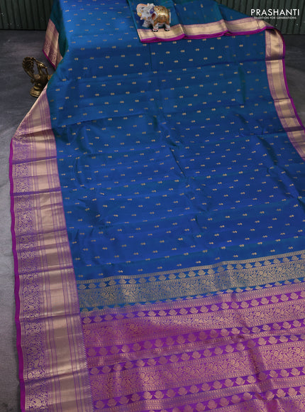 Kanchipuram silk saree peacock blue and magenta pink with allover zari woven buttas and long rich zari woven border